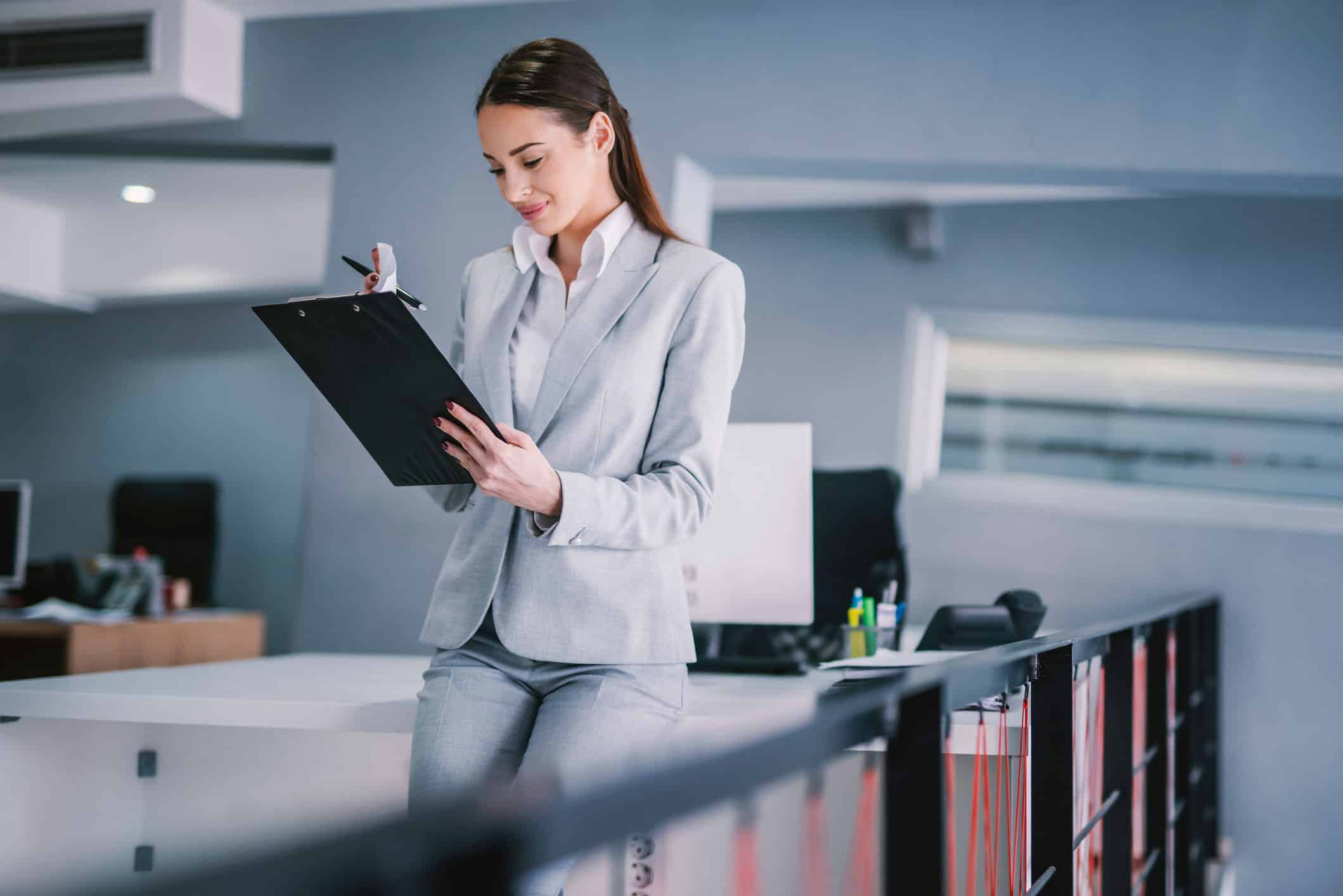 GettyImages-1373266110 An administrative services manager consults a list of action items on a clipboard.
