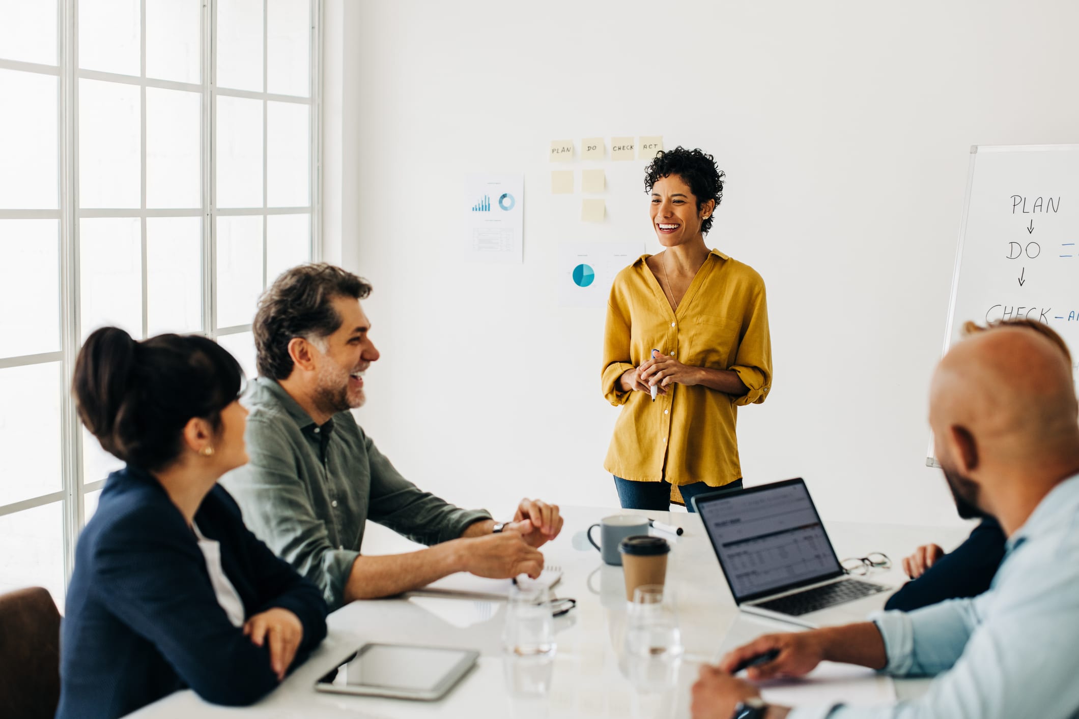 Diverse business people talking in a meeting. Business team having a discussion in a boardroom A team leader addresses colleagues sitting around a conference table.
