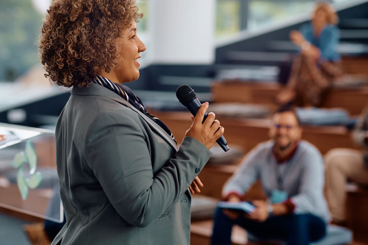 A director of community impact leads a town hall meeting.