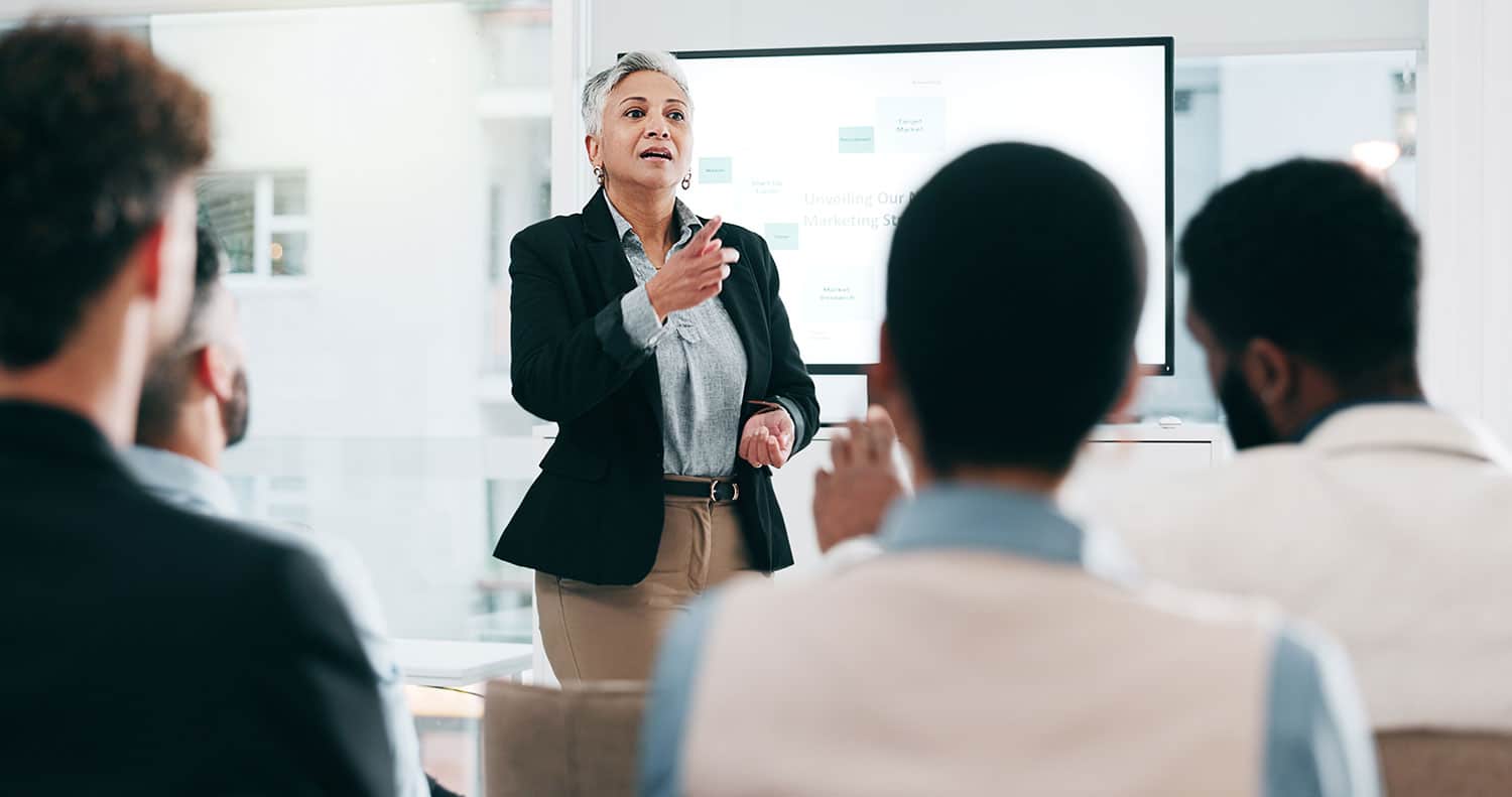 A chief executive officer leads a meeting with an executive team.