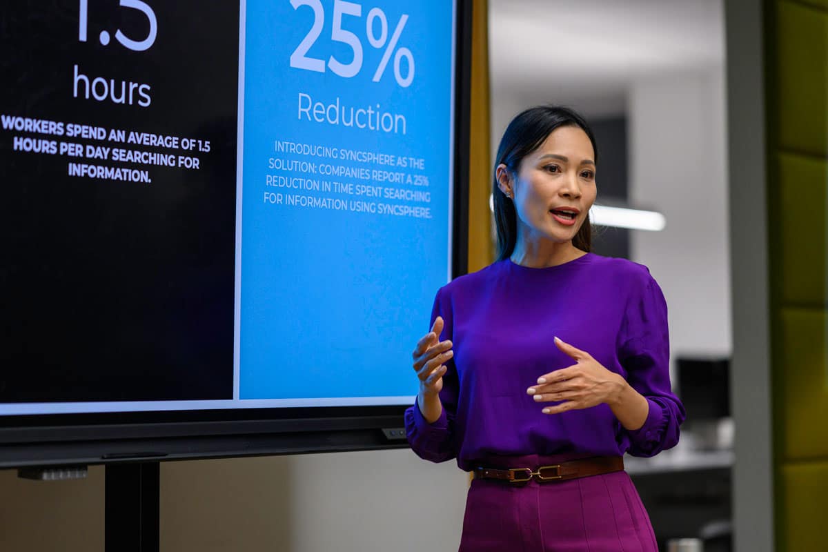 GettyImages-2096682603 A business leader presenting in front of a screen.
